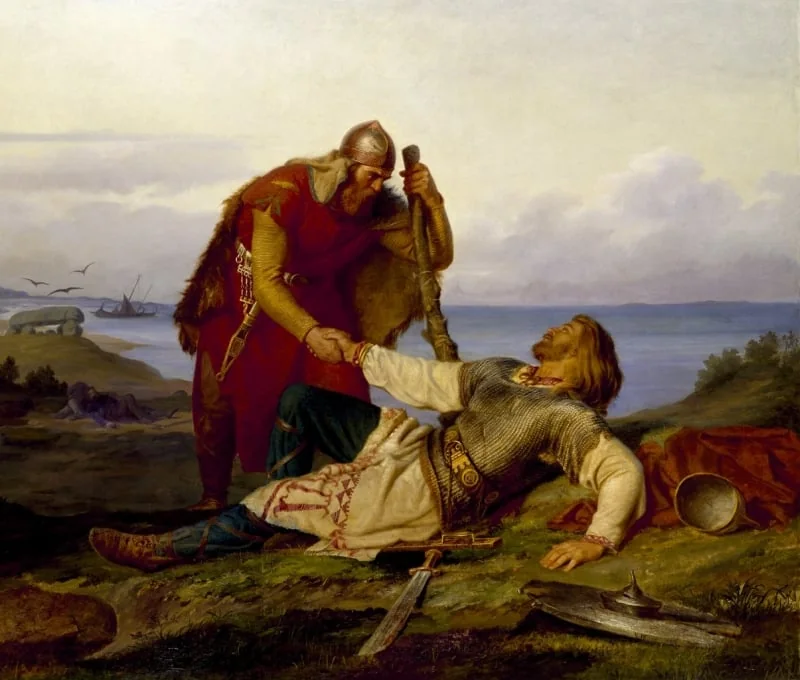 Painting of a Viking clasping the hand of a wounded warrior lying on a headland by the sea